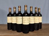 six bottles of wine sitting on top of a wooden table