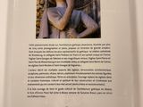 the back cover of a book with a picture of a statue