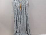the dress is hanging on a hanger on the wall