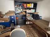 an image of a cluttered room with a desk and a chair