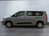 the silver van is parked in a large room with a white wall