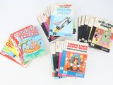 several children ' s books sitting on top of each other on a table