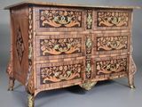 an image of a wooden chest of drawers with carvings on it