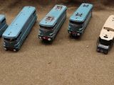 five toy trucks that are sitting next to each other