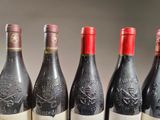 six bottles of wine are lined up in a row on a table