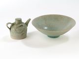 a bowl and a teapot sitting next to each other on a table