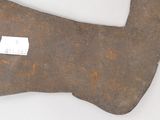 an old axe with a tag on it sitting on a table