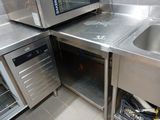 a small kitchen with stainless steel appliances and a sink
