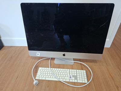 a computer with a keyboard and mouse on a wooden floor