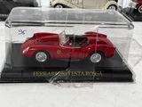 a red toy car in a clear case on a table