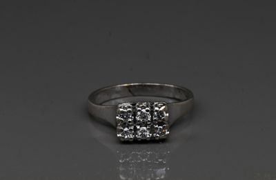 a close up of a diamond ring on a reflective surface