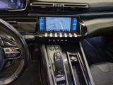 the interior of a car with a touch screen and steering controls