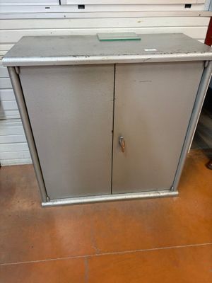 a metal cabinet with a glass top in a room
