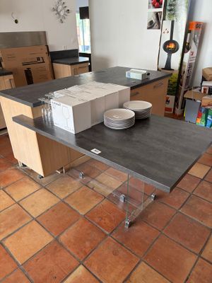 a kitchen with a table with a lot of plates and bowls on it