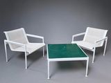 two white chairs and a table with a green top on a grey background