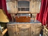 a wooden cabinet with a mirror on top of it
