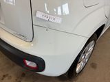 the rear end of a white car with a sticker on it ' s bumper