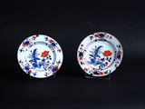 pair of blue and white plates with flowers and birds on them