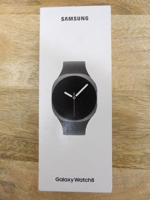 the samsung watch is sitting on top of the box on the table