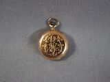 a close up of a gold locke with a chain around it