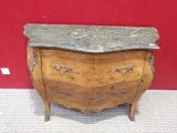 a marble top chest of drawers on display in a museum