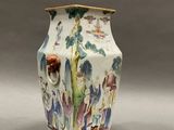 a white vase with a colorful design on it