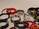 a lot of bracelets and rings on the table