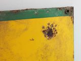 a picture of a yellow and green sign with a dog paw on it