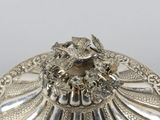 an antique silver plate with a dragon on it