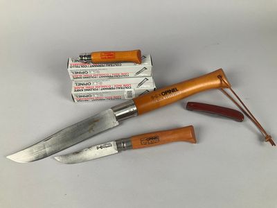 two knives and a box of cigarettes on a table