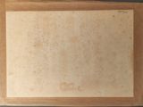 an old photo of a piece of paper on a table
