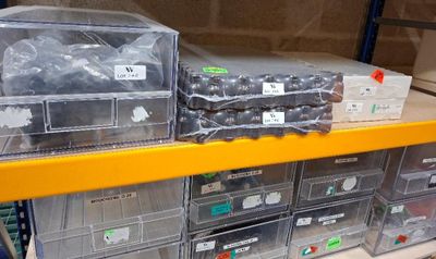 many bins of assorted items on a shelf