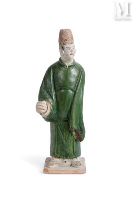 une figurine représentant un homme tenant une balle, posée sur une surface blanche
