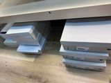 several boxes of apple products stacked on top of each other on the floor