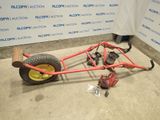 an image of a car with a big wheel on the ground