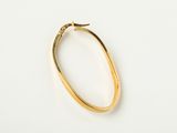 a close up of a gold bracelet on a white surface
