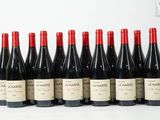 six bouteilles de vin rouge alignées sur une table