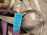 a blue tag on a pair of shoes that are tied to a rope