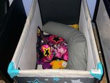 a baby crib with a bed and a pillow in it
