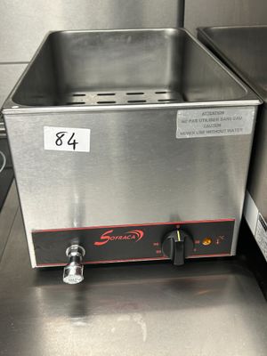 stainless steel counter top with a deep fryer in the middle of it