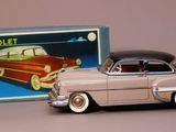 toy car in front of a box with a picture of a car