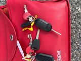 a red bag with a bunch of keys in it