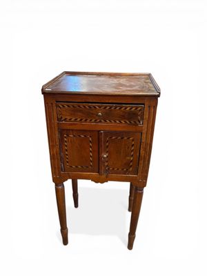a small wooden table with a drawer on it