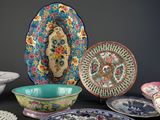 many plates and bowls sitting on a black table