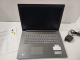 a laptop that is sitting on a table with a charger
