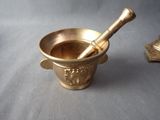 a mortar and a pestor in a cup on a table
