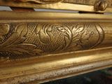 a close up of a gold frame with a clock on it