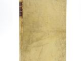 an old book sitting on top of a white surface