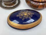 a blue and gold plate sitting on a table next to a bowl