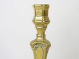 a gold candle that is sitting on a table